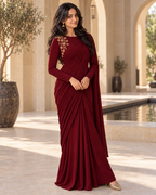 Model in a plum pre-draped satin saree with gold shoulder embroidery