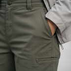 Closeup of olive green utility trouser fabric and cargo pocket detail