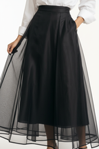 Close-up of black organza midi skirt waistband and sheer fabric layers