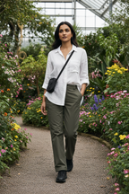 Olive green utility trousers on model in botanical garden