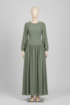 Sage green drop-waist maxi dress displayed on a mannequin