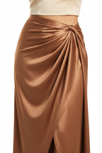 Close-up of bronze satin wrap skirt knot detail and fabric drape