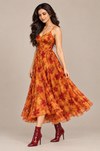 Three-quarter view of orange leaf-print frock