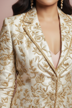 Closeup of ivory gold embroidered blazer detail
