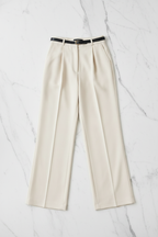 Cream wide-leg trousers flat lay on white marble, no model
