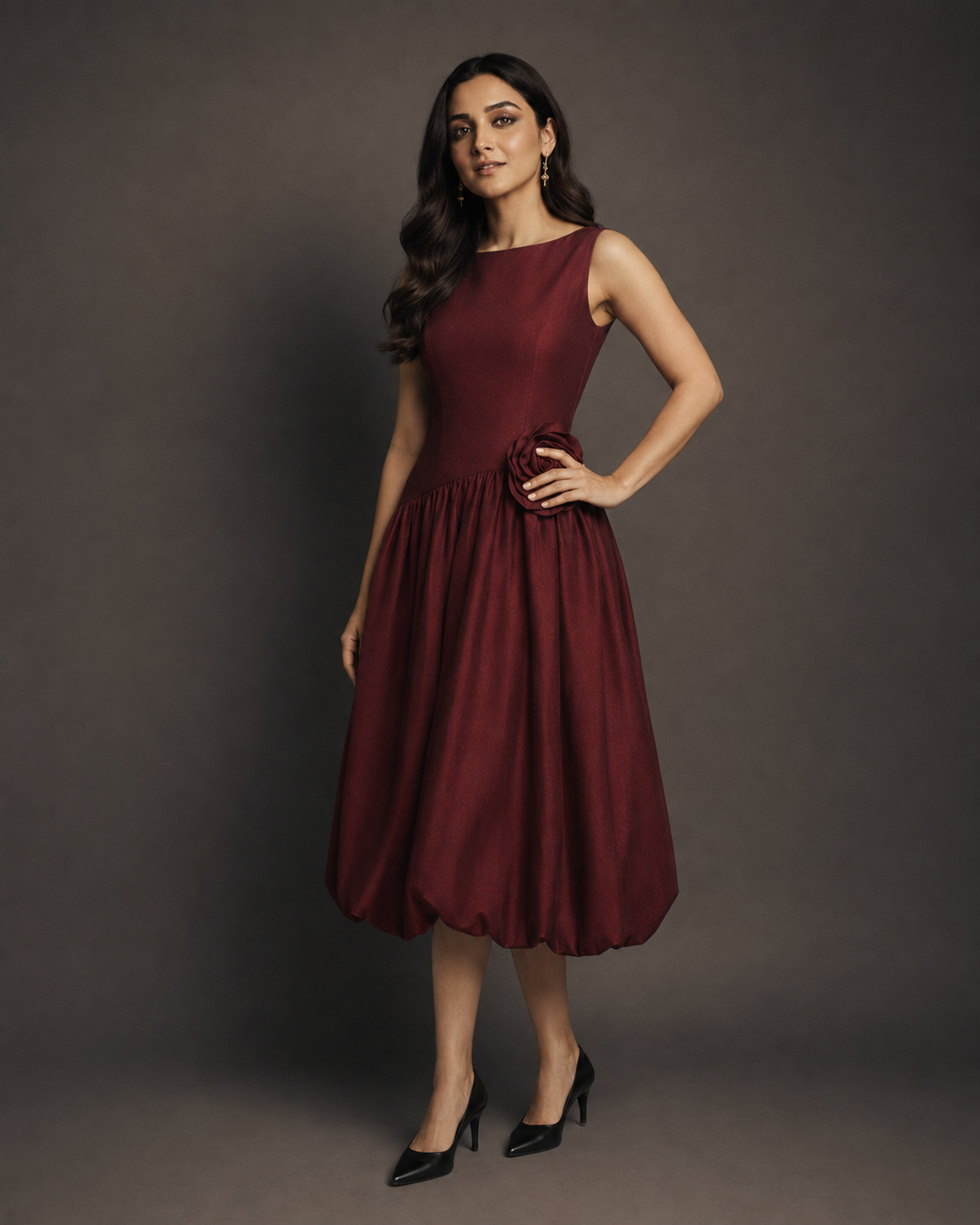 Muze wearing the Kritzy Garnet Bloom occasion frock in a bold, confident pose